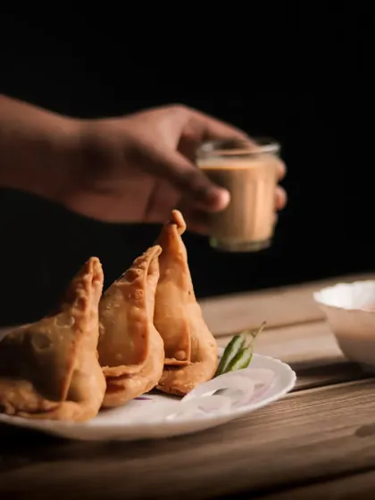 My first attempt at food photography, featuring classic Indian samosas and chai. I used a single light source to create a moody, dramatic look that highlights the texture of the food.