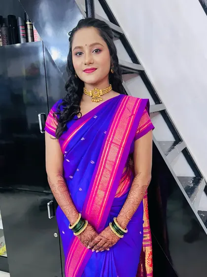 A full portrait of the client in a beautiful blue and pink saree. This look is elegant and perfect for a wedding guest.