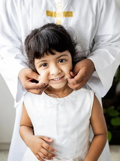 A sweet, playful moment between siblings during a Holy Communion celebration at home. Even during events, I look for these candid interactions that show the family's love.