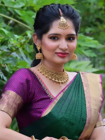 A beautiful portrait of the bride for her engagement. The makeup features a soft golden smokey eye and a reddish-pink lip, which brings out the lovely colors in her silk saree.