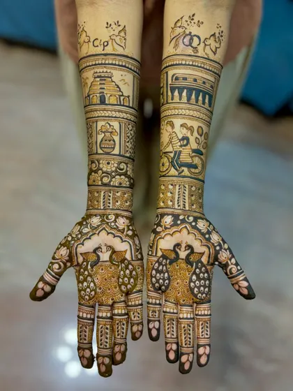 A full view of the storytelling engagement mehendi, showcasing the unique illustrations on both arms.