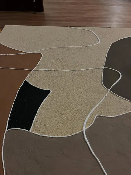A close-up of the abstract canvas, showing the rough texture of the material and the clean white lines that define the shapes.