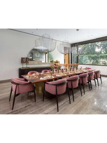Another perspective of the K Residence dining room, showing the large mirror that reflects the Seher Shah artwork on the opposite wall. This use of reflection enhances the sense of space and adds another layer of visual interest.