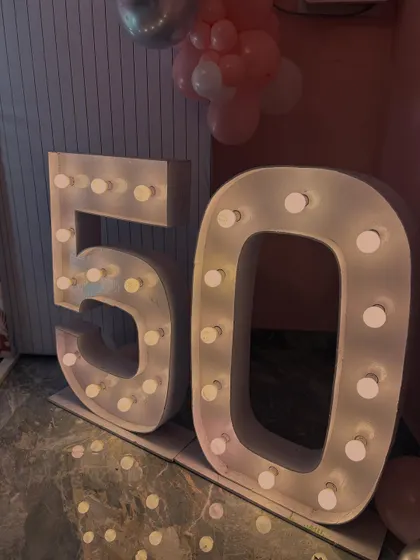 Close-up of the '50' marquee numbers that were a highlight of this milestone birthday celebration. These light-up numbers are a great addition to any party decor.