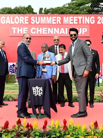 Dr. Muthaiah Ramaswamy, Chairman of the Madras Race Club, presents The Chennai Cup to the winning owners of Emphatic.