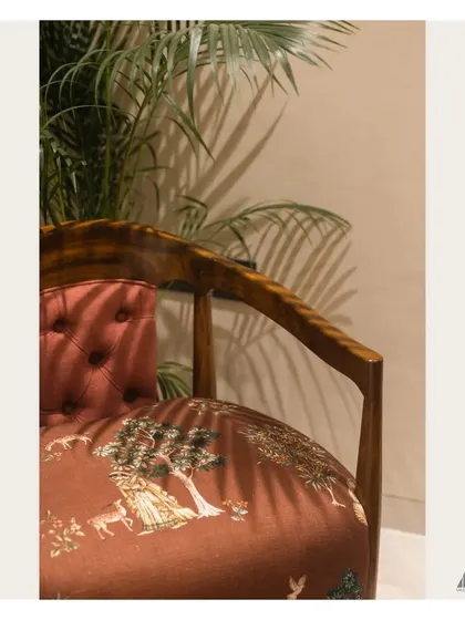 A detail of the custom accent chair, showing the rich wooden frame and the beautifully patterned upholstery. Such pieces add personality and a touch of bespoke luxury to a room.