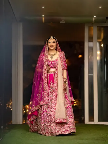 A full-length indoor portrait of the bride, showcasing her complete bridal look with grace and elegance.