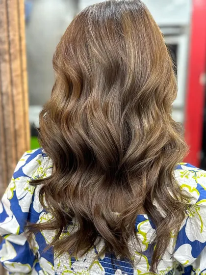 Another fantastic hair makeover by a student. The combination of a rich global color and soft waves gives the hair a healthy, voluminous, and luxurious finish.