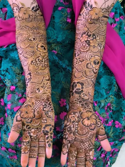 Heavy bridal mehendi for the bride who wants it all. This design covers the arms completely with a rich tapestry of floral and traditional Indian patterns.
