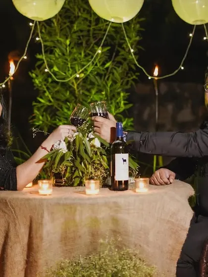 Following the proposal, we documented the couple's private celebration. This shot shows them toasting to their future at a beautifully arranged, candlelit dinner table.