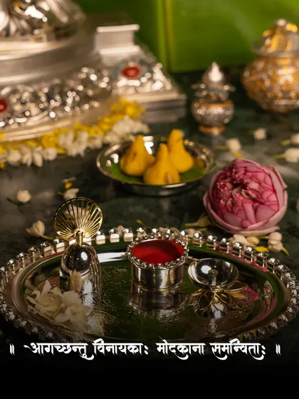 Celebrate the divine arrival of Ganpati Bappa with my handcrafted Pooja Thali. This image captures the essence of the festival, with a silver thali, modaks, and a lotus flower creating a scene of timeless elegance.