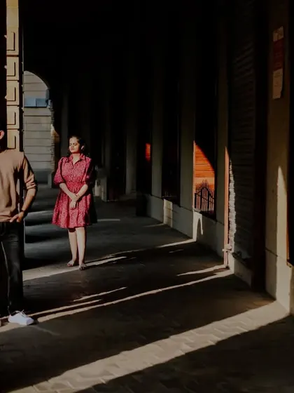 A creative use of light and shadow in an architectural corridor for a dramatic and artistic pre-wedding portrait.
