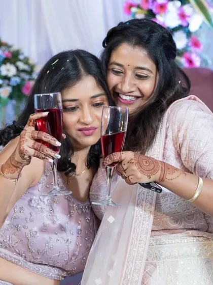 The bride and her friend or sister sharing a toast.