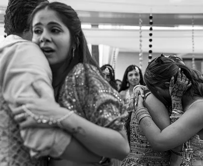 A powerful moment of connection and emotion. This black and white shot captures a heartfelt hug between family members, showing the tears and love that are so central to a wedding day.