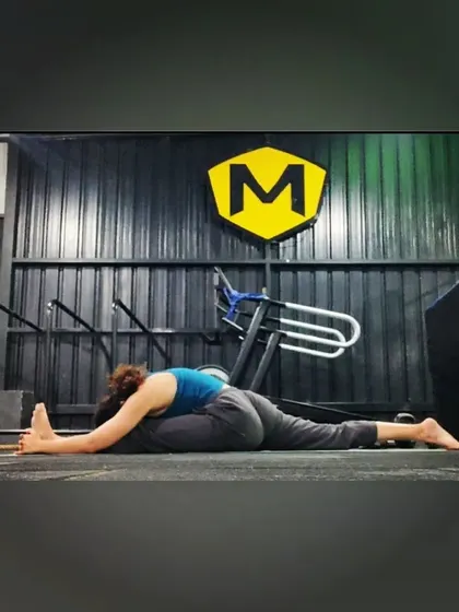 Holding the forward fold in the front split. Breathing through the intensity is key to allowing the muscles to release.
