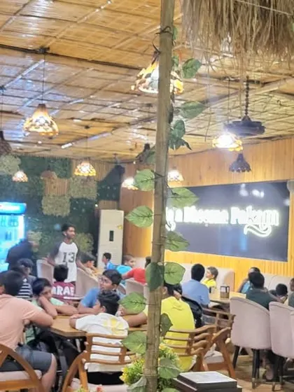 A wider view of the team enjoying a meal together at a restaurant in Hyderabad.