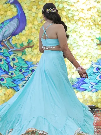 A full view of this mermaid inspired Haldi look. The flowing blue lehenga and Rapunzel like braid create a unique and stunning style.
