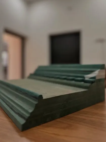 A sample of the custom-molded MDF cornice before installation. We designed the profile to be bold and structural, providing the perfect base for the decorative wallpaper border that would ultimately give it a unique, layered finish.