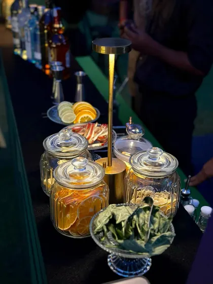 My bar setup includes a variety of fresh and dehydrated garnishes, like oranges, lemons, and herbs, allowing for beautiful and flavorful custom cocktails.