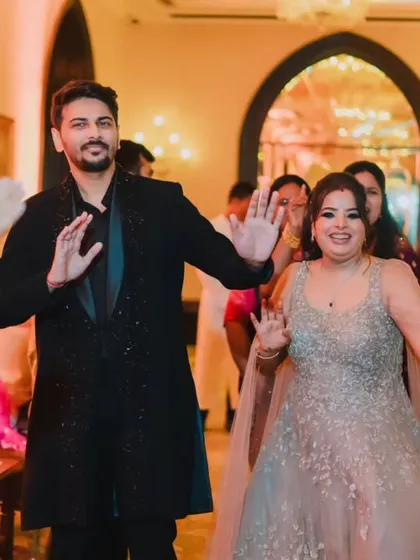 The couple enjoying their reception entrance, dancing and smiling as they are welcomed by their loved ones.