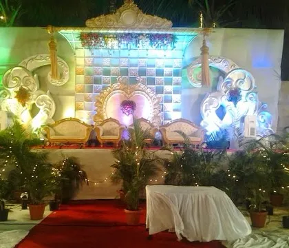 A slightly different angle of the reception stage, showing the detailed carving work on the backdrop and the elegant seating arrangement.