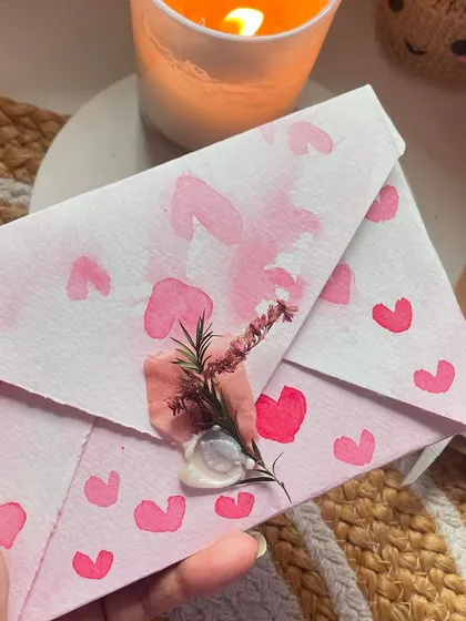 The back of the hand-painted envelope, sealed with wax and a sprig of dried flowers. The presentation is just as important as the card itself!