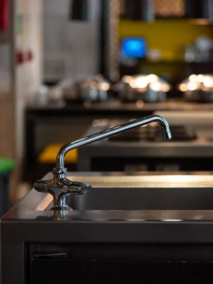 An on-location shot of a T&S Brass faucet in a commercial kitchen. This image showcases the product's durability and suitability for professional environments.