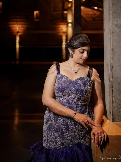 A close-up of the hand-embroidered bodice of the purple sangeet gown, showing the intricate crystal work.