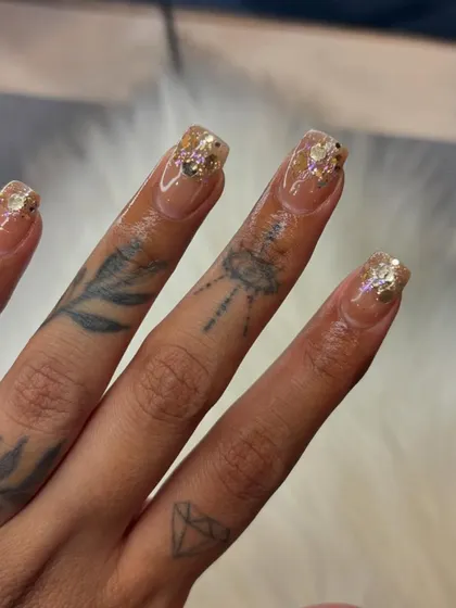 A touch of chunky gold glitter at the tips adds a little party to a clean, natural-looking manicure. It's all in the details.