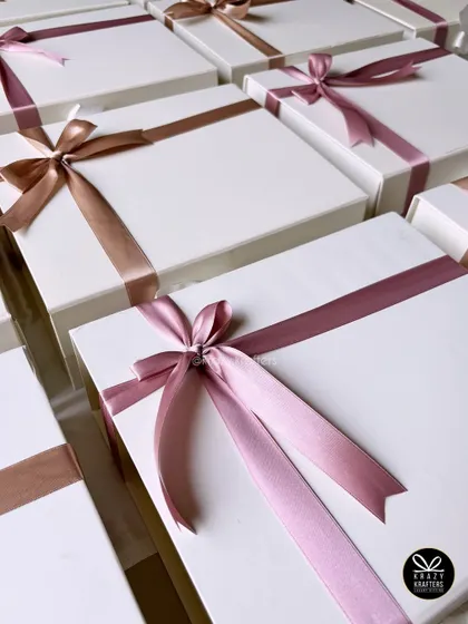 A beautiful array of our signature gift boxes with satin ribbons in various colors, ready for customization and delivery.