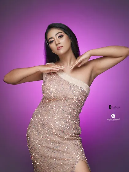 This shot shows the versatility of the makeup and outfit, looking stunning against a simple purple backdrop.