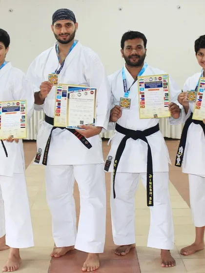 I am proud to stand with my students who won gold and silver medals at the International Online Karate Championship. Their success is a reflection of the entire academy's commitment.