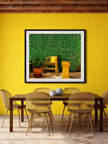 A bold yellow accent wall brings energy and warmth to this dining area. The simple wooden dining set and large window allow the color to be the star, creating a cheerful space for family meals.