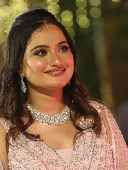 A close-up portrait showcasing the flawless base and soft, blended eyeshadow of this reception glam.