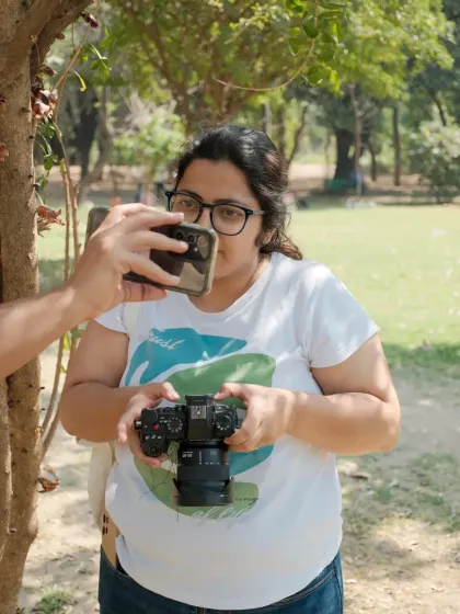 A meta-moment where someone is taking a photo of me while I'm holding my camera. It shows the layers of observation in my life.