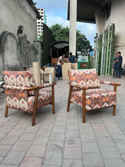 A pair of lounge chairs upholstered in a bold, ikat-patterned fabric. This shows my ability to work with client-specified fabrics to create truly custom pieces.