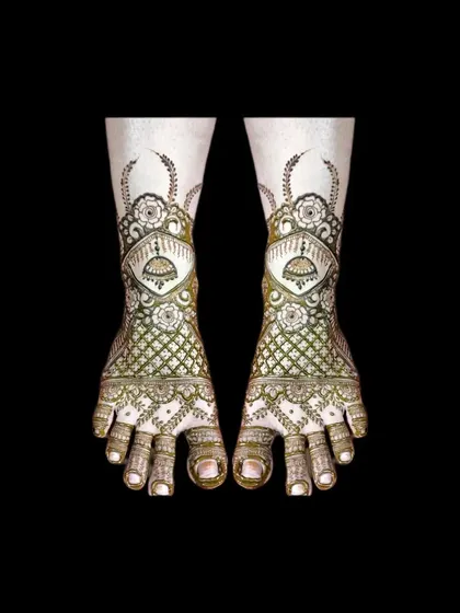 A very detailed and traditional bridal foot design. It features jhumkas, jaali work, and floral elements for a complete look.