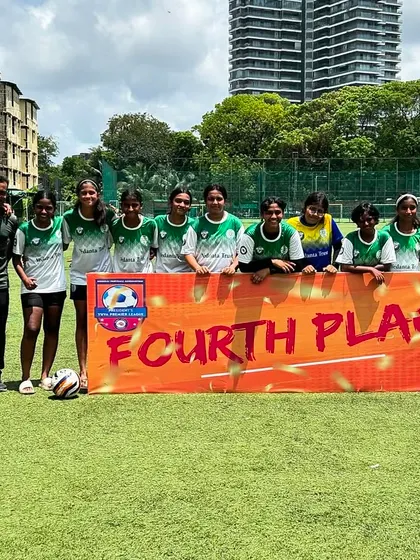 Our U17 girls team and coaches pose with a "Fourth Place" banner after the MFA Girls YPL season. This photo celebrates their hard work and proud finish in a long and challenging league.