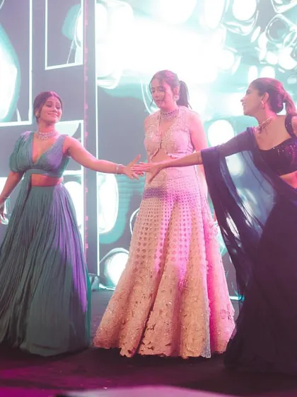 A sweet moment between the bride and her sisters on stage. I love choreographing dances that celebrate the special bond between siblings.