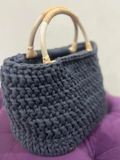 A different angle of the T-shirt yarn bag, showing its roomy interior and strong construction.