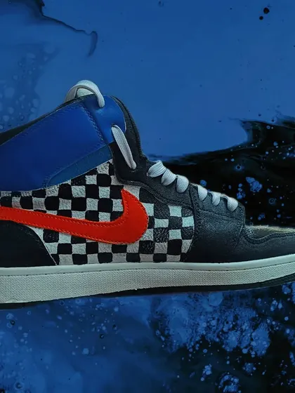 Your sneakers don't have to be boring. I customized these high-tops with a classic checkerboard pattern and a bold, contrasting swoosh, giving them a unique, retro skate vibe. I can paint on leather or canvas to completely transform your footwear.