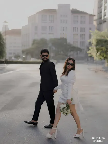There is a certain magic to an empty city street at dawn. For this shoot, we embraced a modern, chic aesthetic, creating images that feel like stills from a contemporary film. The contrast of their black and white outfits against the urban architecture tells a story of confident, stylish love.