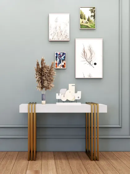 A simple yet elegant console table with a white top and slender gold legs, perfect for a contemporary or minimalist space.