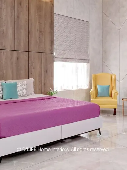 This bedroom design uses a pop of color with a magenta bedspread against a neutral backdrop of white marble-patterned walls and wood-finish wardrobes.