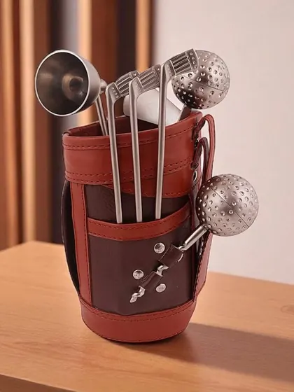 A closer look at the Golf Miniature Bar Kit. The set includes a jigger, tongs, and stirrers shaped like golf clubs and balls, all neatly stored in a detailed faux leather golf bag.