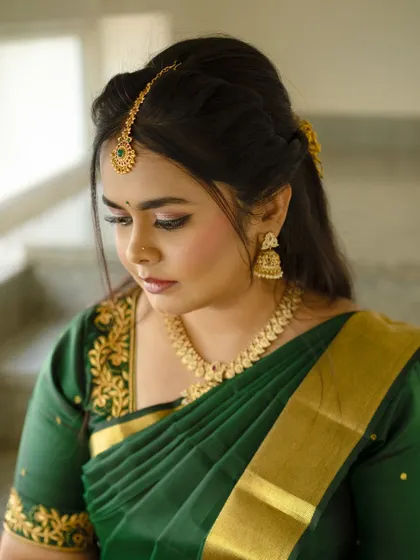 A close-up of Dr. Meghana's makeup, showing the soft, neutral eyeshadow and perfectly defined brows that complete her traditional look.