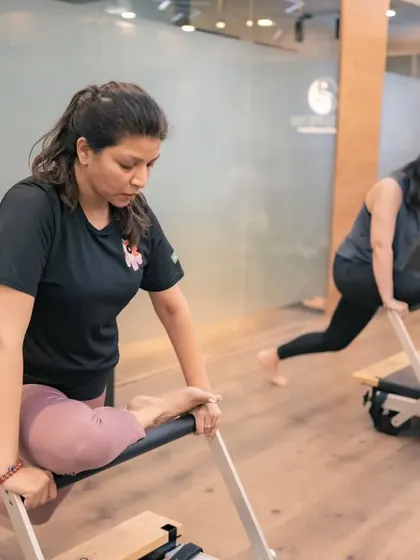 This mermaid stretch variation on the Reformer not only stretches the side body but also requires core strength to control the movement of the carriage.