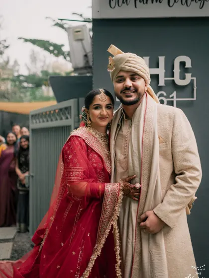 A happy couple poses in front of the 'FHC 1961' sign, a signature spot at our venue. This is a great photo opportunity to remember your special day.