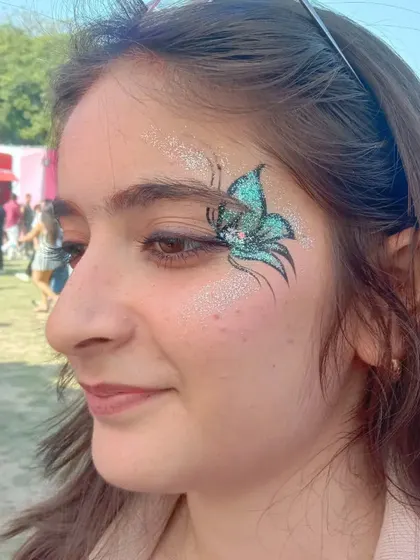 This blue-green butterfly design is filled with fine glitter, creating a shimmering, almost aquatic effect.
