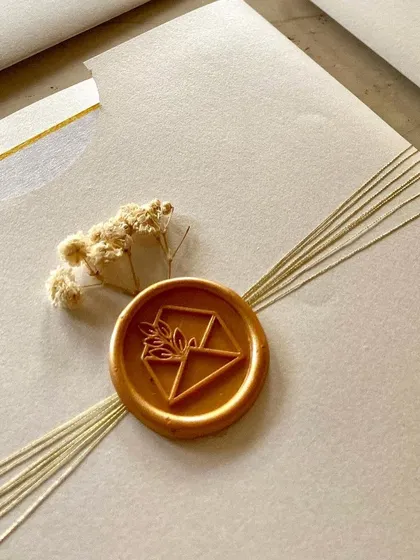 These beautiful flat envelopes were created for a private home ceremony. The design is minimal and elegant, featuring a simple thread wrap, a custom wax seal, and a tiny sprig of dried flowers.